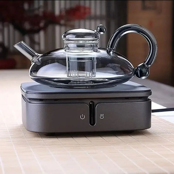 Elegant glass teapot on a modern heating base, showcasing its stylish design and heat-resistant features.