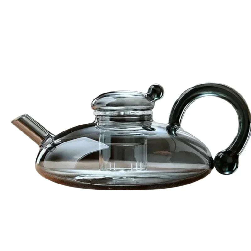 Elegant glass teapot with a modern black handle and heat-resistant borosilicate design.