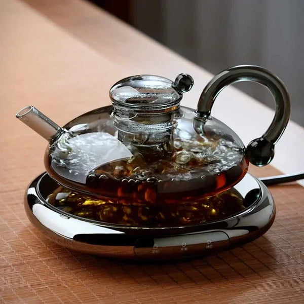 Elegant glass teapot with modern black handle and heat-resistant design, perfect for brewing loose-leaf tea.